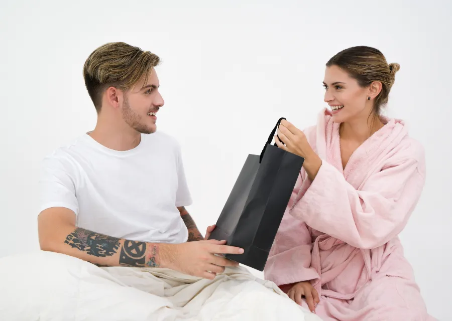 A couple exchanging a gift bag