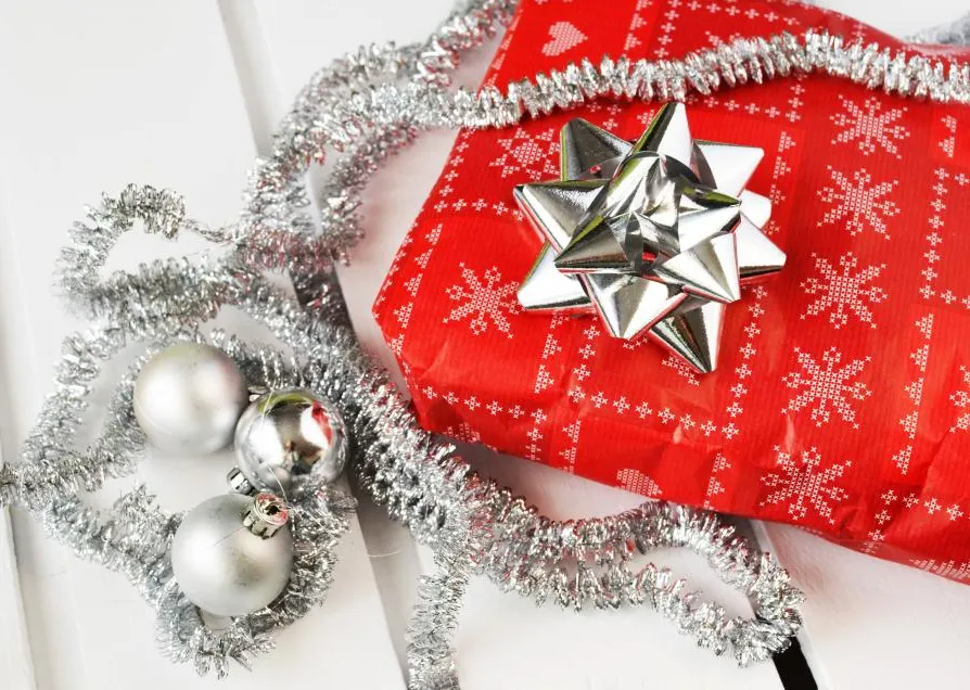 A wrapped gift with a silver bow