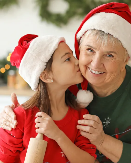 Grandmother and granddaughter in Christmas hats