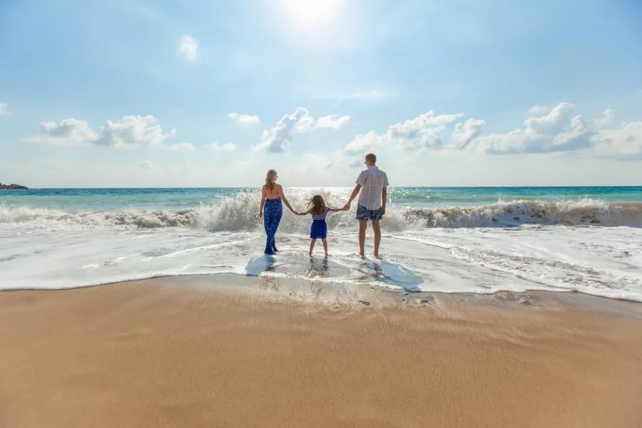 Family paddling at the beach